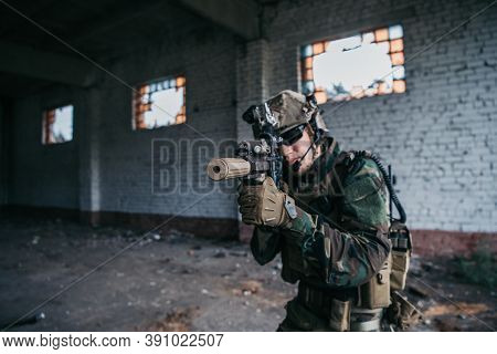 Military Soldier In The Form Holds In The Hands An Assault Rifle, Check Possible Enemies Around The 
