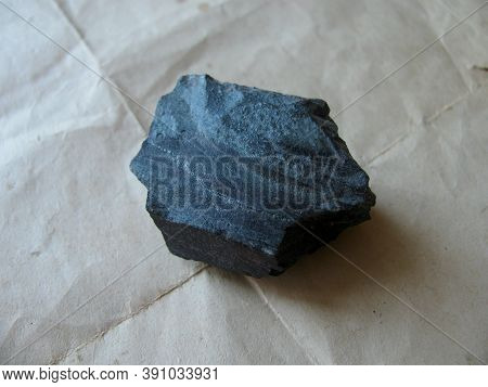 Grey Ferruginous Quartzite On The Background Of Old Craft Paper