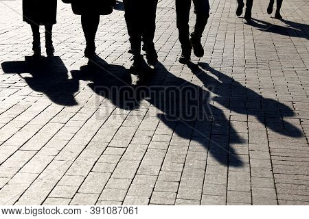 Silhouettes And Shadows Of People On The City Street. Crowd Walking Down On Sidewalk, Concept Of Cri