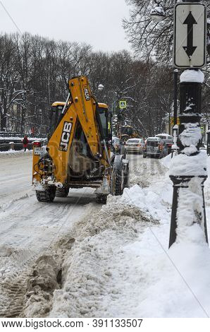 Saint Petersburg, Russia - February 06, 2018: Yellow Tractor Jcb Clearing The Road After A Snowfall 