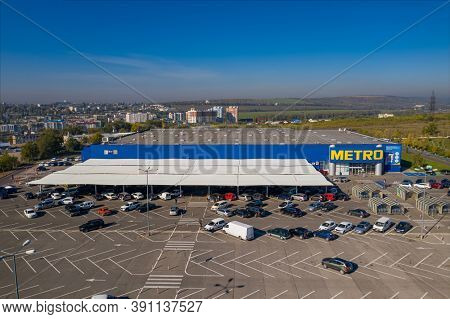 Chisinau, Moldova - October, 2020: Metro retail store, large shopping mall of household and food goods with parking, aerial view, copyspace