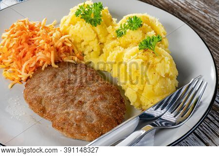 Homemade Minced Meat Cutlet Served With Mashed Potatoes And Carrot Salad.