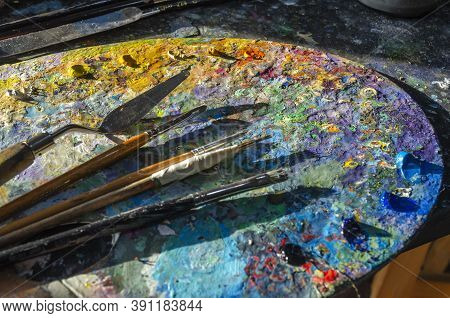 Painter Palette With Colours And Brushes