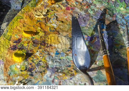 Painter Palette With Colours And Brushes