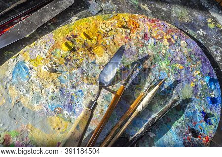 Painter Palette With Colours And Brushes