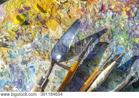 Painter Palette With Colours And Brushes