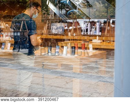 Paris, France - Oct 23, 2020: View From The Street Of Apple Genius Employee Looking At New Iphone 12