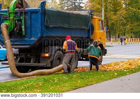 Moscow. Russia. October 11, 2020. Utility Workers Remove Yellow Autumn Leaves With An Industrial Vac