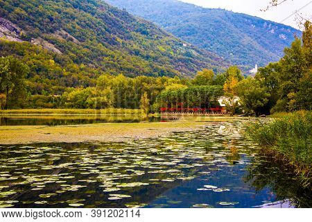 Blue Clouds Are Reflected On The Lake With Wooden Jetty On The Lakes Of Revine, Treviso, Veneto, Ita