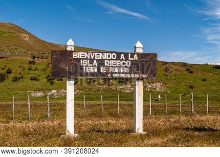 Riesco Island, Chile - December 12, 2008: White On Brown Wooden Welcome Sign At Ferry Landing.