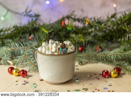 A Gingerman In A Mug With Hot Cocoa And Marshmallow. Christmas Holiday Decorations And Blurred Xmas 