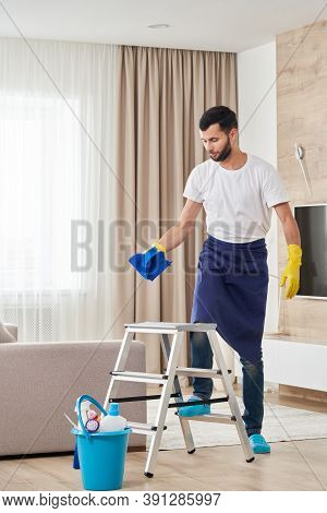 Man Climbing Ladder To Clean Ceiling. Cleaning Service Concept