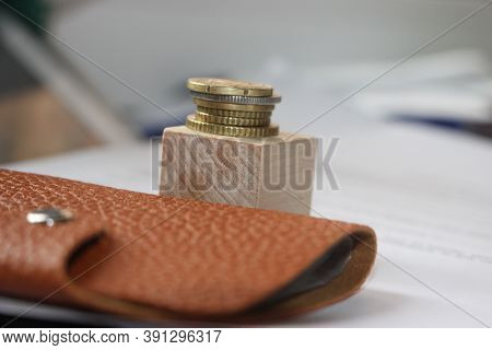 Brown Leather Wallet And Stack Of Bronze Coins Put On Wooden Cube. Little Money Or Powerty Concept. 