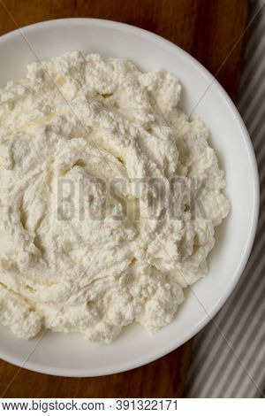 Tasty Ricotta Cheese In A White Bowl, Top View. Overhead, From Above, Flat Lay.