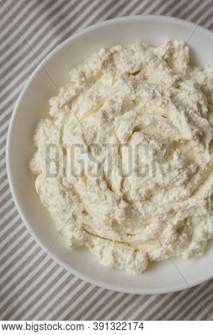 Tasty Ricotta Cheese In A White Bowl, Top View. Overhead, From Above, Flat Lay. Close-up.