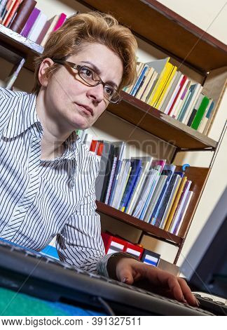 Portrait Of A Busy Woman Teleworking At Her Desk At The Home. Working At Home Became An Important Re