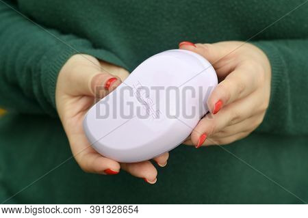 Young Girl Holds Tangle Teezer Pink Hairbrush. Tangle Teezer Is A British Manufacturer Of Detangling