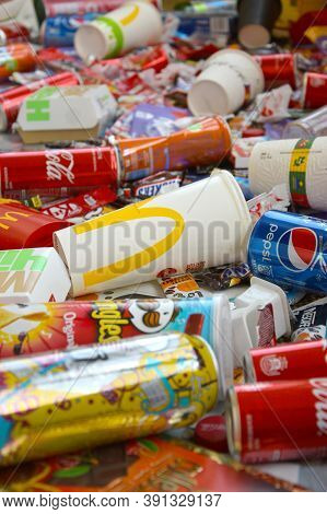 Many Wrappings And Cans From Used Products By Famous Worldwide Brands. Pattern Of Trash Of Various C