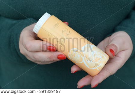 Young Girl Holds Oriflame Volare Fragranced Body Talc. Oriflame Holding Ag Is A Multi-level Marketin