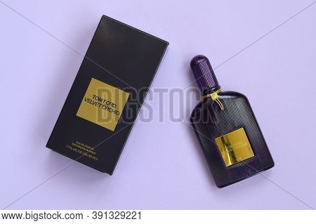 Tom Ford Velvet Orchid Fragrance Perfume Bottle Lies On Light Lilac Background. Tom Ford Is American