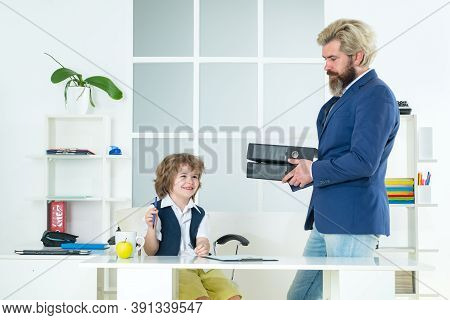 Businessman Father With His Son Drawing On Business Papers At Office. Team Of Business People Having
