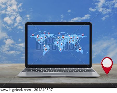 Map Pin Location Button With Connection Line And World Map On Modern Laptop Computer On Wooden Table