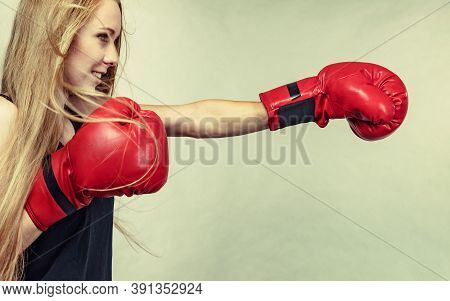 Bloned Long Hair Girl Boxer In Big Fun Red Gloves Playing Sports Boxing. Female Fight For Equal Righ
