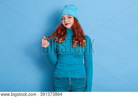 Cheerful Young Girl With Toothy Smile Pulling Her Hair Aside, Looking At Camera With Smile, Wearing 