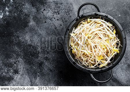 Sprouts Of Sprouted Beans In A Colander. Vegetarian Food. Black Background. Top View. Copy Space