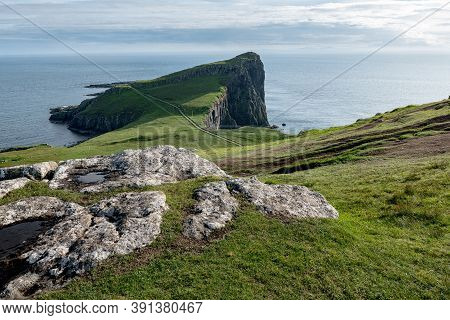 Landscape Of Peninsula At Neist Point At Isle Of Skye, Scotland With Stones In The Foreground