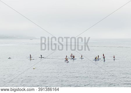 Sanxenxo, Spain - August 26, 2020: A Group Of Young People Enjoy Practising Paddle Surf In The Ria D