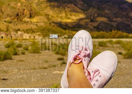 Female Feet In Sierra Alhamilla Landscape, Spain. Caravan At El Chorillo Movie Location In The Backg