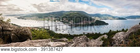 Panorama View Of The Ria De Vigo Estuary From Redondela On A Cloudy Summer Afternoon, With The Recen