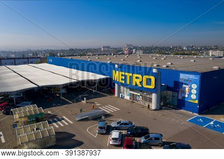 Chisinau, Moldova - October, 2020: Metro retail store, large shopping mall of household and food goods with parking, aerial view, copyspace
