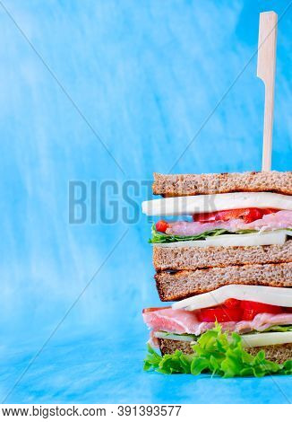 Multilayered Club Sandwich With Cheese, Pork Balyk, Bell Pepper, Lettuce Leaves And Toasted Bread Ag