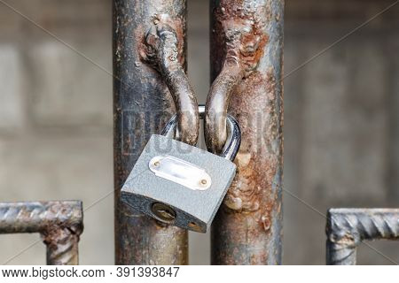 Locked Lock Old Rusty Metal Door Close Up. Antique Slide Steel Locked Shutter Door. The Lock, On The