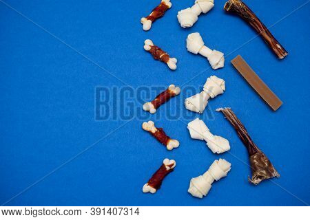 Variety Of Dog Treats. Dod Delicacy Food On Blue Background