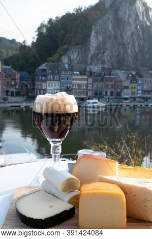Glass Of Belgian Abbey Beer And Tasting Of Cheeses Made With Trappist Beer And Fine Herbs With View