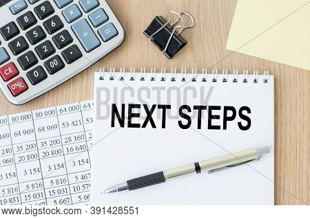 Next Steps Text On A Notebook On The Office Desk. Business Concept