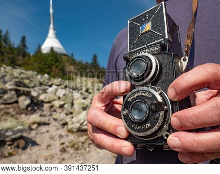 Older Photographer Man Using Vintage Film Camera During Trip To Jested Mountain. Jested. 16th Of Sep