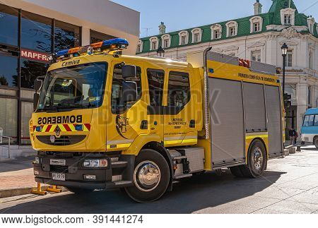 Punta Arenas, Chile - December 12, 2008: Closeup Of Yellow Fire Engine Parked In Street. Buildings B