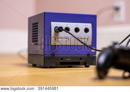 An Indigo Original Gamecube Console, A Popular Retro Console On A Wood Floor.