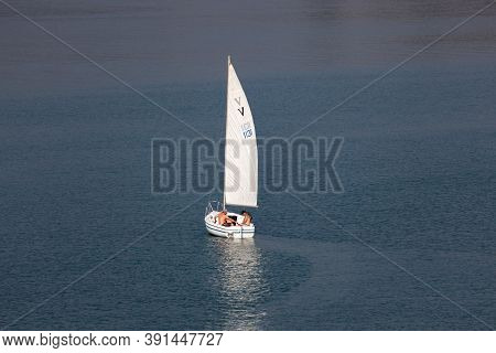 Lost Creek Lake Near Prospect,  Oregon / Usa - September 7, 2014:  Three Men In A Small White Sailbo