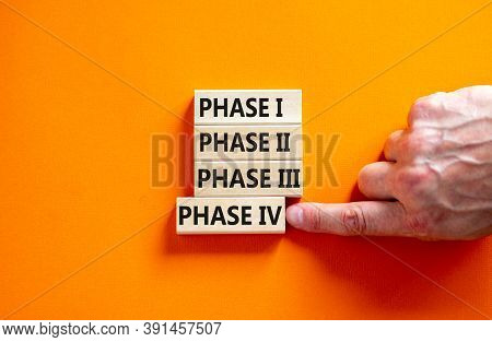 Time To Phase 4. Wooden Blocks Form The Words 'phase, 1, 2, 3, 4' On Orange Background. Male Hand. B