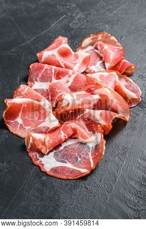 Italian Rolled Bacon Pancetta Piacentina. Pork Meat. Black Background. Top View