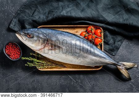 Fresh Whole Japanese Amberjack. Raw Fish Yellowtail. Black Background. Top View