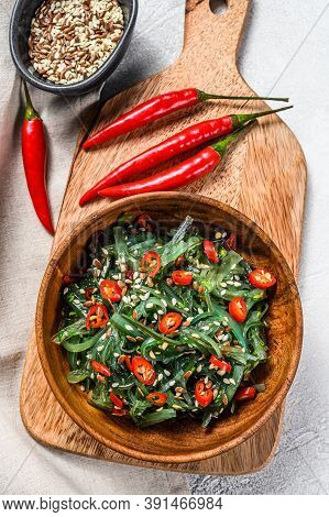 Healthy Seaweed Chuka Salad With Greens And Red Chili Pepper. Gray Background. Top View