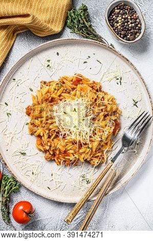 Orzo Pasta, Risone With Bolognese Sauce And Ground Beef In A Plate. Gray Background. Top View