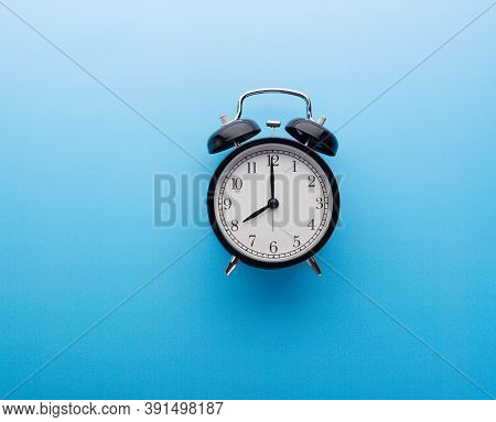 Black Retro Alarm Clock Showing Eight O'clock, Closeup Top View Clipping Path, Isolated On Blue Back