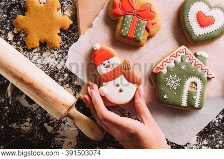 Christmas Bakery. Festive Decorated Pastry. Homemade Biscuits. Unrecognizable Female Hand Holding Gi